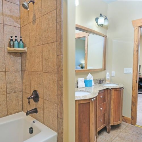 The en suite bath comes with a double vanity, large tub/shower combo, and a spacious closet.