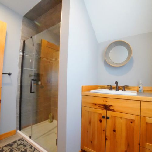 The recently renovated bathroom enjoys a large walk-in shower and a cozy vanity.