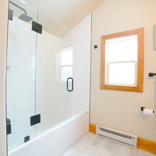 The upstairs bathroom has a large tub/shower condo and a lovely modern vanity.