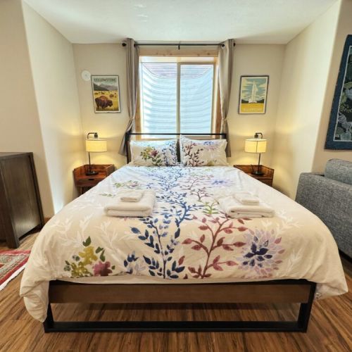 Two beds are in the shared living space — one queen and one king.