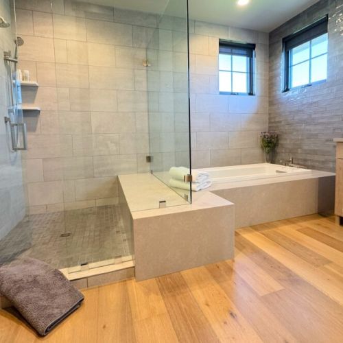 The primary en suite enjoys a large walk-in shower, a soaking tub, and a spacious double vanity.