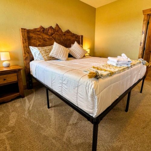 The primary bedroom enjoys a king bed with a custom Teton headboard. It also has an en suite bath and a desk for those who need to work-from-home.