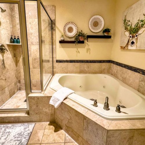 The primary en suite enjoys a spacious double vanity, a walk-in shower, and a large tub.