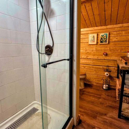 The loft apartment bathroom has a walk-in shower to go with its rustic charms.