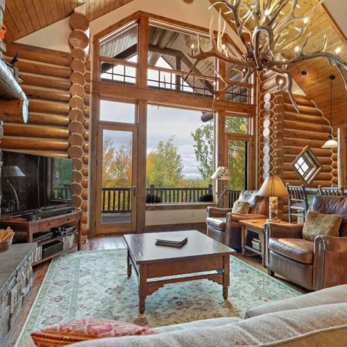 Relax in the spacious living room, accented with lovely logs and mountain decor.