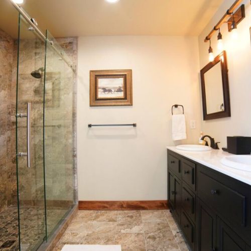 The upstairs hall bath has a double vanity and large walk-in shower.