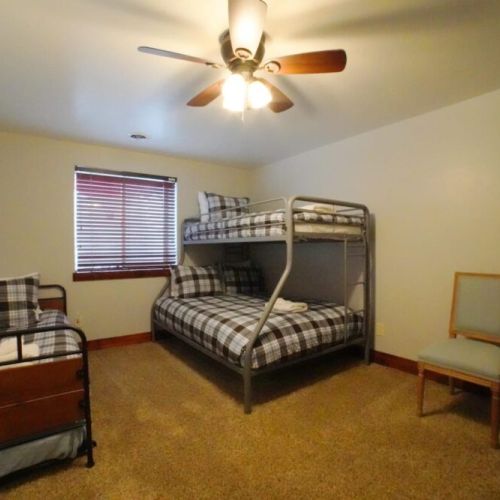 Bedroom #5 has a roomy bunkbed, as well as a twin. The room also enjoys a closet and dresser.