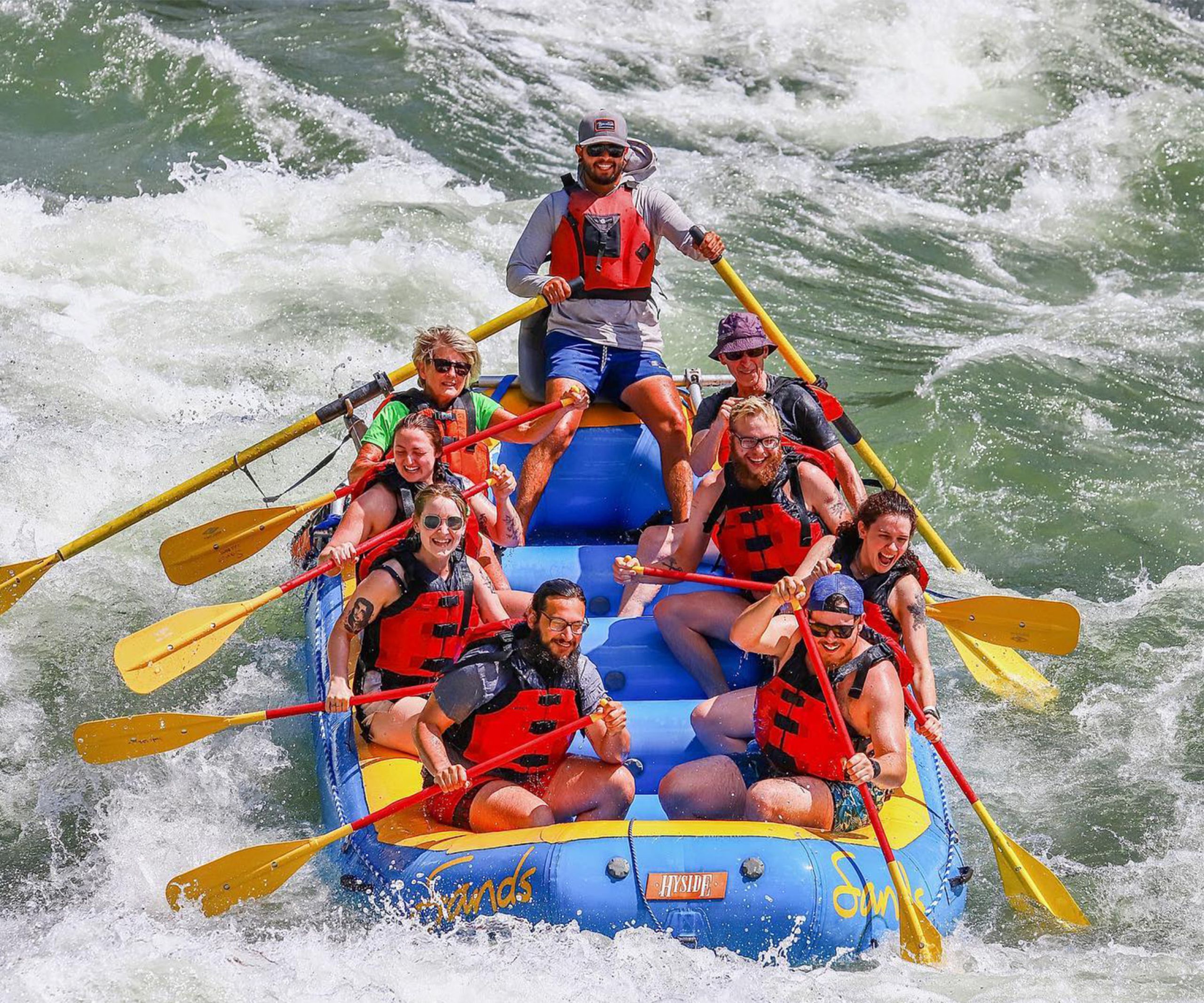 A group whitewater rafts the Snake River.