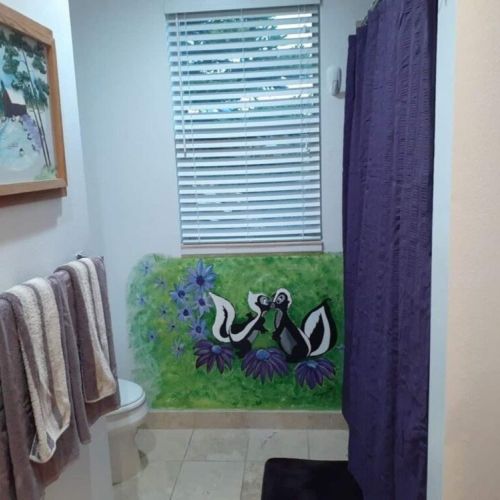 Bedrooms #2, #3, #4, and #5 share this downstairs bathroom, featuring a vanity and a tub/shower combo.