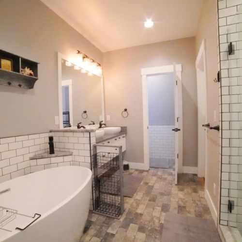 The en suite bathroom features a soaking tub, walk-in shower, and a double vanity.