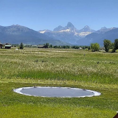 Playing on an in-ground trampoline in the shadow of the Tetons is a one-of-a-kind experience for kids (and adults, too)!