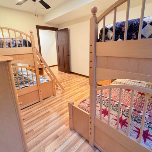 Bedroom #4, also located in the basement, has two twin-over-full bunk beds.