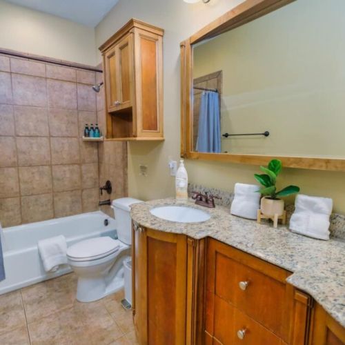 Bedrooms #2 and #3 share this full bath, featuring a large tub/shower combo and a double vanity.