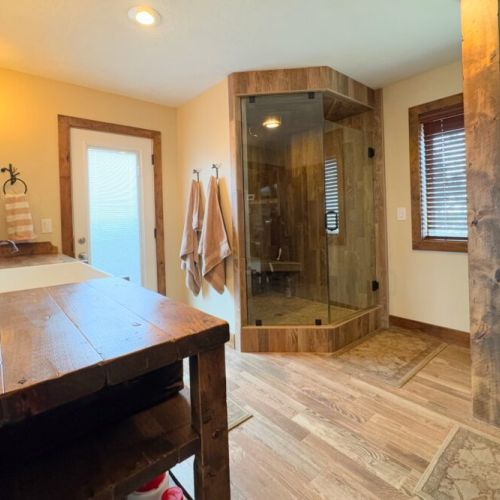 The primary en suite enjoys an expansive double vanity, a walk-in shower, and  direct access to a private hot tub.