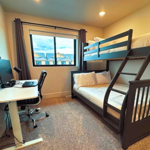 Bedroom #3 has a twin XL-over-full bunk bed, as well as its own workstation with a computer monitor.