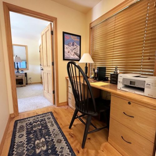 The hallway to Bedroom #2 has a desk — perfect for any guests who need to work-from-home.