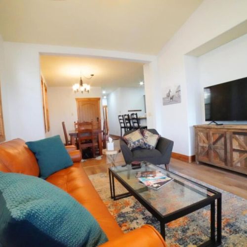 Whether you are chatting at the kitchen island, sitting at the table, or lounging in the living room, you are always a part of the fun in this condo.
