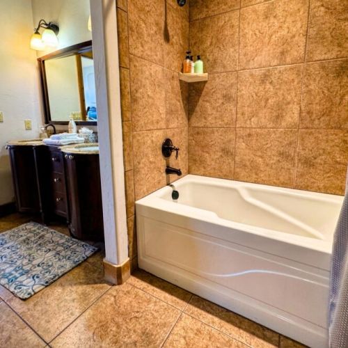 The en suite bath comes with a double vanity, large tub/shower combo, and a spacious closet.