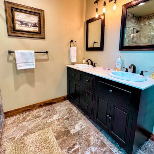 The upstairs hall bath has a double vanity and large walk-in shower.