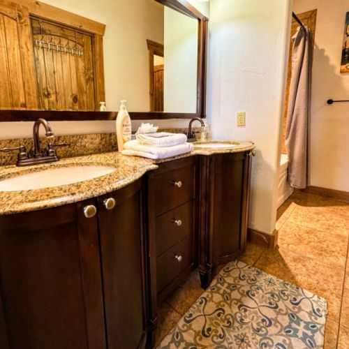 The en suite bath comes with a double vanity, large tub/shower combo, and a spacious closet.