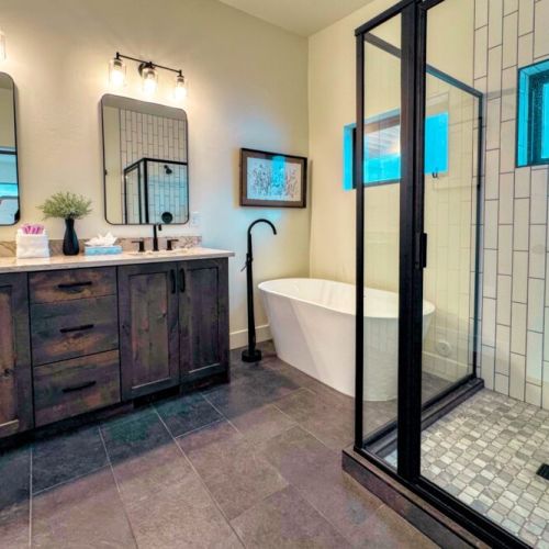 The primary en suite enjoys a large walk-in shower, a soaking tub, and a spacious double vanity.