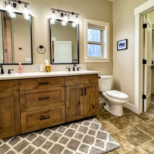 The primary en suite enjoys a spacious double vanity, a luxurious step-in shower, and access to the walk-in closet.