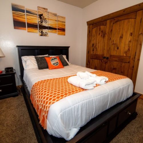 Bedroom #3 has a great queen bed and access to a porch shared with Bedroom #2. It also has a mounted TV.