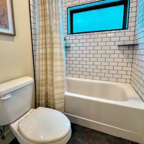 The Jack-and-Jill-style bathroom (shared by Bedrooms #2 and #3) features a double vanity and a tub/shower combo.