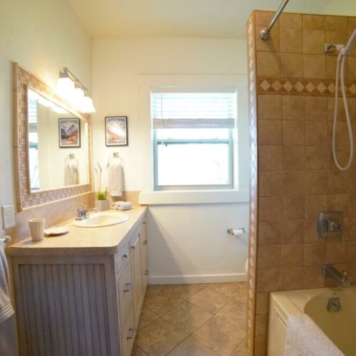 The upstairs area shares a bathroom, featuring a vanity and a tub/shower combo.