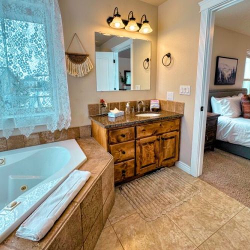 The primary en suite enjoys a large vanity, a luxurious jetted tub, and access to the walk-in closet.