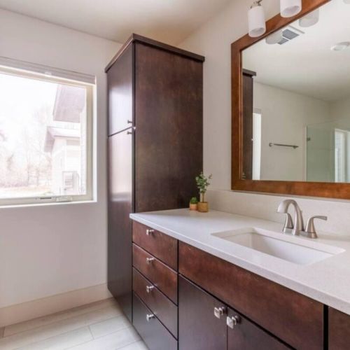 The en suite bath enjoys a spacious vanity and a walk-in shower.