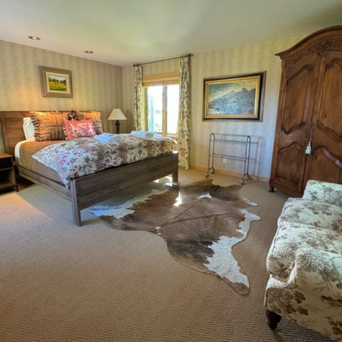 The master bedroom has a king bed, lovely sitting space,  a walk-in closet, and an en suite bath.