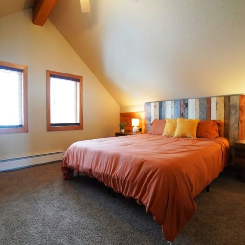 This upstairs bedroom has a king bed and direct access to the upstairs bathroom.