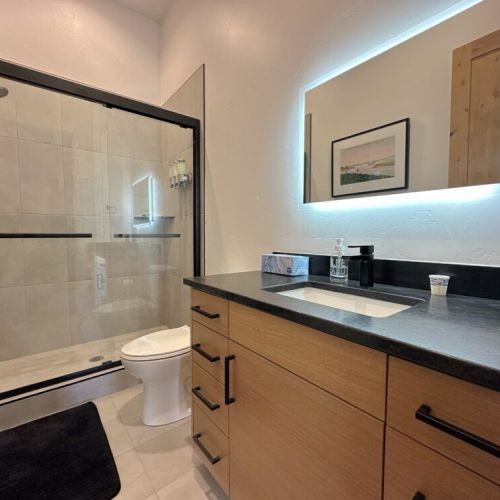 The ground floor full bathroom, shared by bedrooms #2 and #3, features a spacious vanity and large walk-in shower.