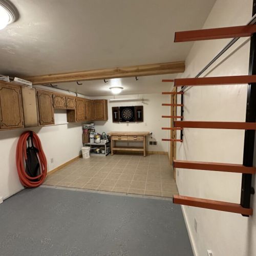 The basement also enjoys a spacious utility space with ample space for storing gear and luggage, as well as a dart board for a little fun.