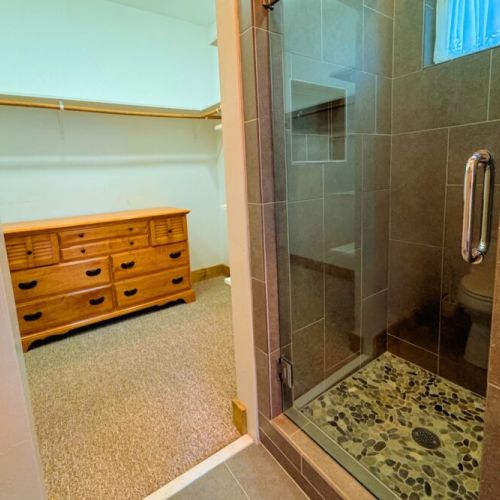 The primary en suite enjoys a spacious double vanity, a luxurious tub, and a step-in shower.