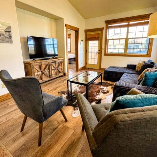 Whether you are chatting at the kitchen island, sitting at the table, or lounging in the living room, you are always a part of the fun in this condo.