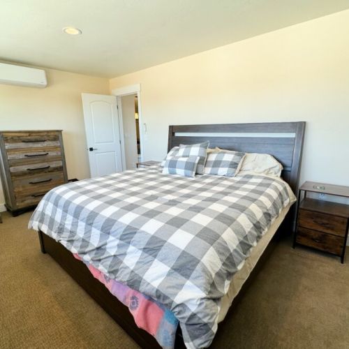 The private bedroom comes equipped with a king bed, a dedicate mini-split unit, plenty of storage space, and direct access to the Jack-and-Jill bathroom.