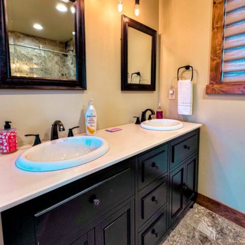Bedroom #2's en suite bath has a double vanity and a large walk-in shower.
