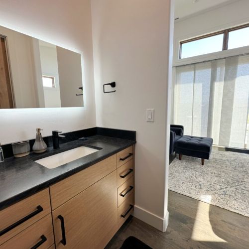 The master en suite features his-and-hers vanities and a luxurious walk-in shower.