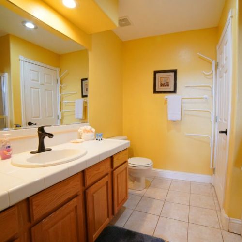 Bedroom #2's en suite bath has a vanity, a tub/shower, and plenty of storage space.