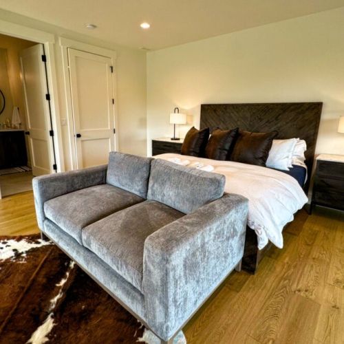 Bedroom #4 (upstairs) is functionally another master! It comes with a king bed, a love seat, a TV, a large en suite, as well as a fantastic balcony overlooking the backyard.