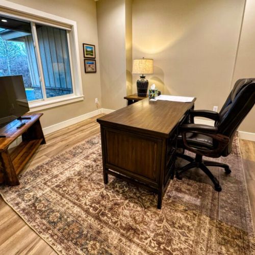 In case you have to work-from-home, there is an office off of the living room that is equipped with a desk, its own TV, and a view out in the front yard.