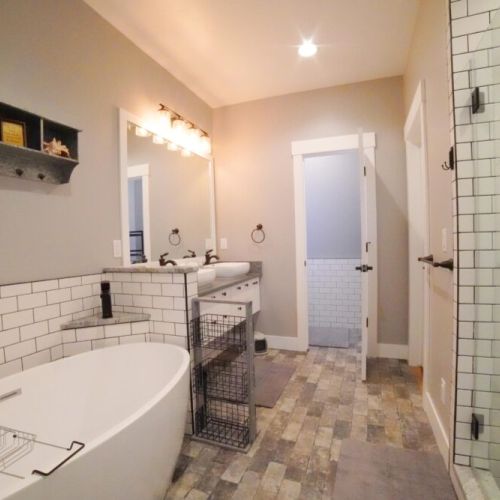 The en suite bathroom features a soaking tub, walk-in shower, and a double vanity.
