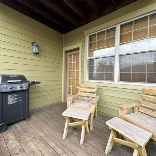 Just off the living area is a small porch, complete with a couple lounge chairs and a propane BBQ.