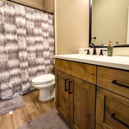 Bedrooms #2 and #3 share a full bathroom, which features a large vanity and a tub/shower combo.