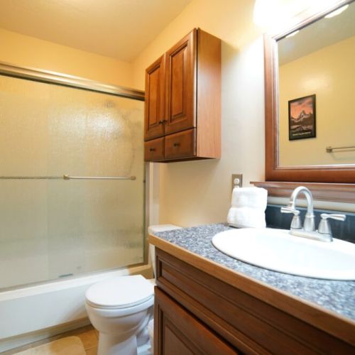The upstairs bathroom has a large tub/shower combo and a vanity for getting ready or winding down.