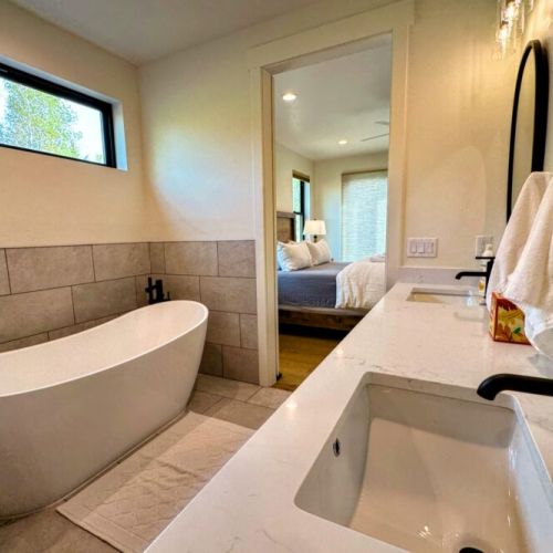 The ground floor master en suite has a spacious double vanity, a walk-in shower, a soaking tub, and a walk-in closet.