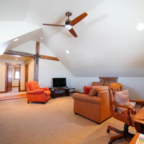 The upstairs features another common area with a TV, as well as a desk for work- or school-from-home.