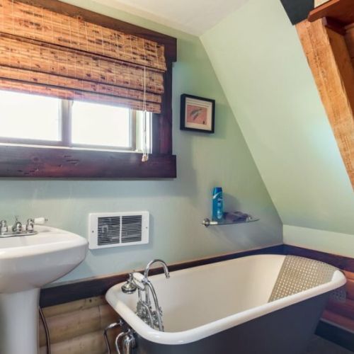 The en suite bathroom enjoys a lovely tub and direct access to the sauna.